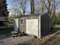 Large detached shed with an overhead garage door, providing ample storage for tools, equipment, or hobbies at 3422 Hillside Ave, Indianapolis, IN 46218
