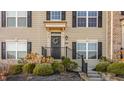 Inviting front porch with a black door, decorative wreath, and well-maintained landscaping at 3535 Buckner Dr, Westfield, IN 46074