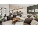 Open-concept living room with modern furnishings and seamless flow to the kitchen and dining area at 3535 Buckner Dr, Westfield, IN 46074
