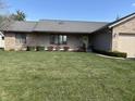 Inviting single-story home with manicured lawn, brick and vinyl siding, and attached garage at 3760 Briar Hill Way, Columbus, IN 47203