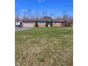 Charming brick ranch home with a large front yard and attached garage at 3922 Dundee Dr, Indianapolis, IN 46237