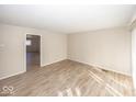 Bright living room with modern flooring, neutral walls, and ample natural light at 4008 N Mitthoefer Rd, Indianapolis, IN 46235