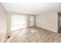 Spacious living room with new wood flooring and large windows bringing in natural light at 4008 N Mitthoefer Rd, Indianapolis, IN 46235
