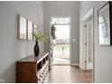 Bright foyer with hardwood floors, decorative console table and view of the front door at 4241 Risen Star Way, Bargersville, IN 46106