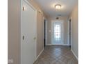 Inviting tiled hallway features a decorative glass front door and white trim at 4655 Welton St, Greenwood, IN 46143