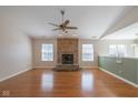 Spacious living room features a brick fireplace, hardwood floors, and large windows at 4655 Welton St, Greenwood, IN 46143