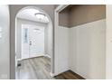 Inviting foyer featuring hardwood floors and a stylish archway to the rest of the home at 4911 Carry Back Ln, Indianapolis, IN 46237