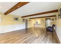 Spacious living room with wood floors, exposed beams, and natural light at 4911 Carry Back Ln, Indianapolis, IN 46237