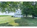 Two-story farmhouse with a screened-in porch and a view of a cornfield at 6045 N 300 W, Greenfield, IN 46140