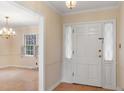 Inviting foyer with neutral walls and tiled floors, creating a warm welcome at 625 Mulberry St, Zionsville, IN 46077