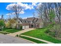Spacious home with a three-car garage, large driveway and lush green yard showcasing ample outdoor space at 7562 Black Walnut Dr, Avon, IN 46123
