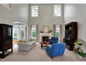 Bright and airy living room with a fireplace, large windows, and neutral carpet flooring for a cozy feel at 7562 Black Walnut Dr, Avon, IN 46123
