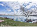 Picturesque waterfront view with boats docked along the shoreline, reflecting the blue sky at 7653 River Rd, Indianapolis, IN 46240