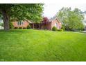 Beautiful brick home with mature trees and a well-maintained lawn at 7732 Ashtree Dr, Indianapolis, IN 46259