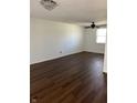 A generously sized bedroom featuring laminate flooring, modern ceiling fan and light-filled windows at 7802 Broadview Dr, Indianapolis, IN 46227