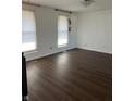 A spacious bedroom with laminate flooring, white walls and natural light at 7802 Broadview Dr, Indianapolis, IN 46227
