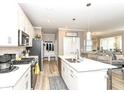 Modern kitchen with white cabinets, stainless steel appliances, an island, and an open floor plan at 811 Harley Ln, Westfield, IN 46074