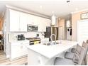 Bright kitchen featuring white cabinetry, a large island with seating, and stainless steel appliances at 811 Harley Ln, Westfield, IN 46074