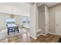 Bright entryway showcases a dining area and a glimpse into the living room with a modern bench at 8818 Tributary Dr, Indianapolis, IN 46259