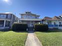 Attractive two-story home featuring a welcoming front porch and lush green lawn at 925 E Main St, Muncie, IN 47305
