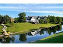 Beautiful waterfront home with lush green lawn and a charming dock at 999 Box Turtle Ct, Columbus, IN 47201