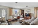 Inviting living room with cozy furniture, including a plush sofa and patterned armchairs and decor at 110 Jordan Ct, Martinsville, IN 46151