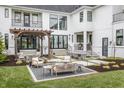 Expansive backyard with a pergola covered sitting area and an outdoor dining space, perfect for entertaining at 11003 Holliday Farms Blvd, Zionsville, IN 46077