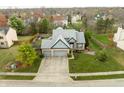 Lovely neighborhood featuring a home with a two-car garage, green lawn, and mature trees at 11229 Echo Ridge Ln, Indianapolis, IN 46236