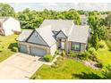 Stunning aerial view of home with lush green landscaping and spacious driveway at 11229 Echo Ridge Ln, Indianapolis, IN 46236