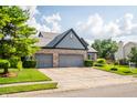 Charming home featuring a large driveway and mature trees at 11229 Echo Ridge Ln, Indianapolis, IN 46236