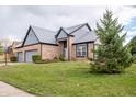Beautiful home with a two-car garage, complemented by lush green lawn and mature trees at 11229 Echo Ridge Ln, Indianapolis, IN 46236