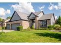 Beautiful home with a lush green lawn and manicured shrubs at 11229 Echo Ridge Ln, Indianapolis, IN 46236