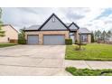 A well-maintained home with a two-car garage, beautiful landscaping, and a welcoming entrance at 11229 Echo Ridge Ln, Indianapolis, IN 46236
