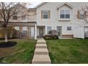 Charming two-story townhouse with neat landscaping, inviting entrance, and a well-maintained lawn at 11475 Clay Ct # 102, Fishers, IN 46037