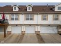 Row of townhome garages with white doors and matching siding for a clean, uniform look at 11475 Clay Ct # 102, Fishers, IN 46037