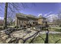 Spacious backyard featuring a brick patio, fire pit, and hot tub for outdoor relaxation at 12065 Watermark Ct, Indianapolis, IN 46236