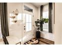 Bright entryway showcasing a white door, stylish decor, natural light, and elegant design elements at 1221 Herbert St, Indianapolis, IN 46202