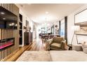 Open-concept living room with modern fireplace, shelving, and seamless flow to the dining and kitchen areas at 1221 Herbert St, Indianapolis, IN 46202