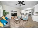 Open-concept living area with modern furnishings, hardwood floors, and a stylish ceiling fan at 1444 English Ave, Indianapolis, IN 46201