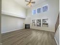 Bright living room featuring a fireplace, soaring ceilings, multiple windows and light, modern flooring at 14466 Chapelwood Ln, Fishers, IN 46037
