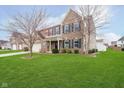 Charming two-story home with brick and siding exterior, well-manicured lawn and attached two-car garage at 1464 Hession Dr, Brownsburg, IN 46112