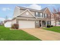 Charming two-story home with brick and siding exterior, well-manicured lawn and attached two-car garage at 1464 Hession Dr, Brownsburg, IN 46112