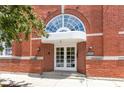 Close-up of a red brick building's entrance with arched window, double doors, and building number 1529 at 1529 Alabama N St # H, Indianapolis, IN 46202