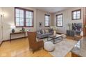 Inviting living room with natural light, hardwood floors, stylish furniture, and neutral color palette at 1529 Alabama N St # H, Indianapolis, IN 46202