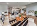 Open-concept living room showcasing hardwood floors, stylish furniture, and seamless flow into the kitchen at 17877 Haralson Row, Westfield, IN 46074