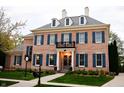 Stunning brick home with blue shutters, dormer windows, and professionally landscaped front yard at 1997 Finchley Rd, Carmel, IN 46032