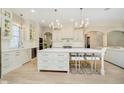 Gourmet kitchen with large island, white cabinetry, modern appliances, and stylish pendant lights at 1997 Finchley Rd, Carmel, IN 46032