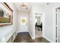 Inviting foyer featuring hardwood floors, a decorative mirror, and a view into a bright office space at 19992 Fenside Xing, Westfield, IN 46074