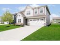 Charming home featuring a well-maintained lawn, complemented by a two-car garage and inviting curb appeal at 19992 Fenside Xing, Westfield, IN 46074