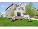 Attractive two-story home with landscaping and a spacious driveway leading to an attached two-car garage at 19992 Fenside Xing, Westfield, IN 46074